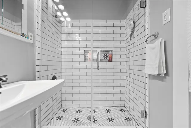 a bathroom with a sink a toilet and shower