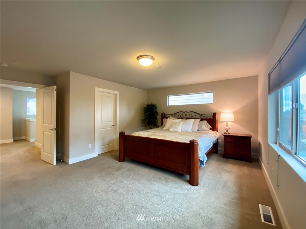 5208 Northeast 11th Place Renton, WA 98059 - Photo 14 of 29 a bed room with a bed and a lamp
