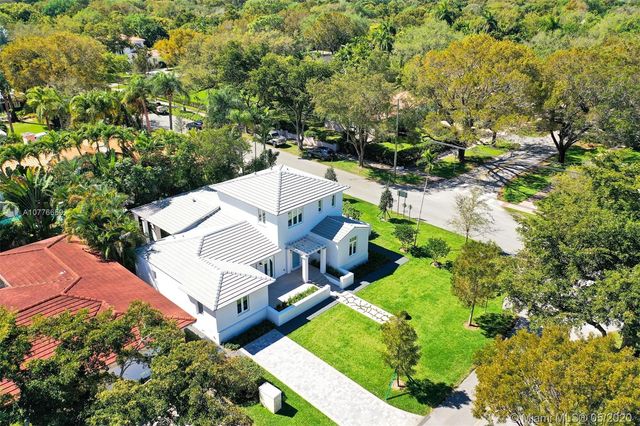 an aerial view of a house with yard swimming pool and outdoor seating