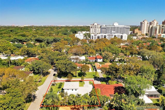 an aerial view of house with a yard