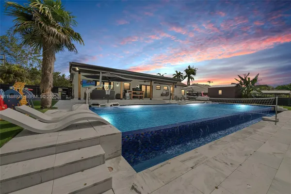 a view of a swimming pool with an outdoor seating