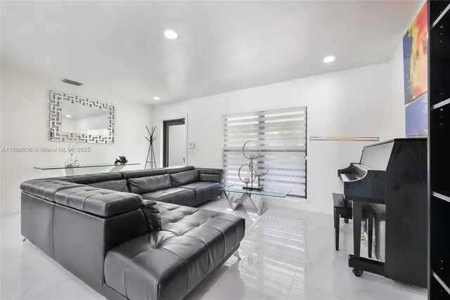 a living room with furniture a fireplace and a chandelier