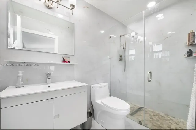 a kitchen with white cabinets and appliances