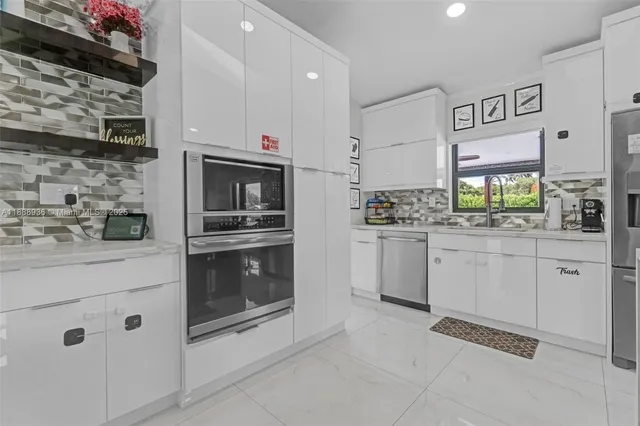 a bathroom with a double vanity sink mirror and bathtub