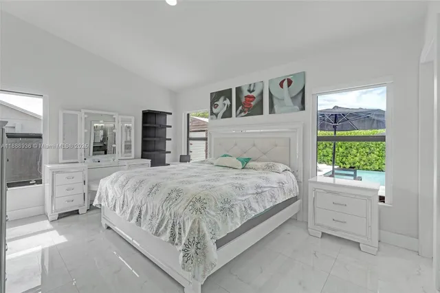 a bedroom with a large bed and a couch