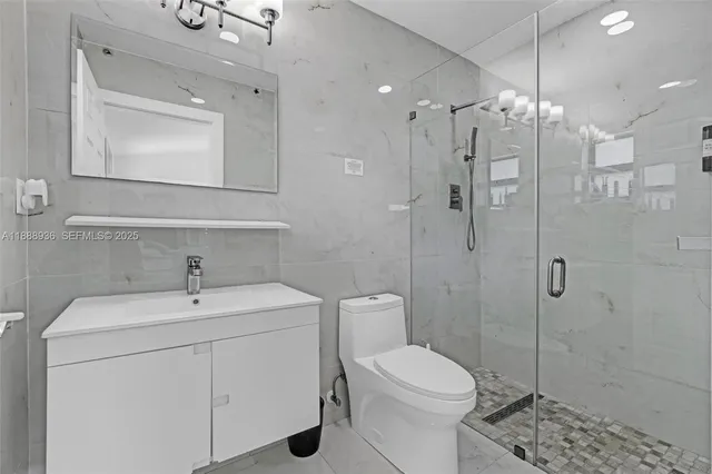 a bathroom with a shower a toilet and sink