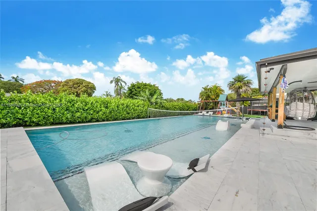 a view of swimming pool with seating space