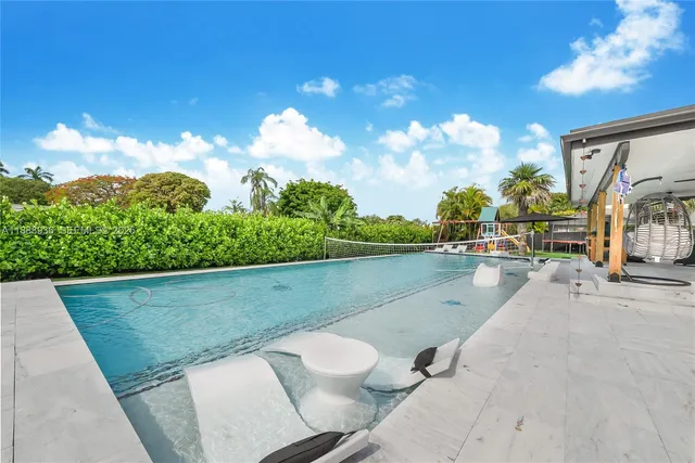 a view of swimming pool with seating space