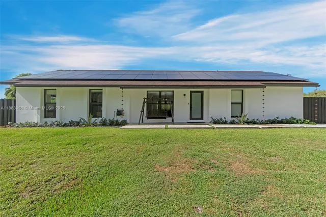 a view of a house with swimming pool and sitting area