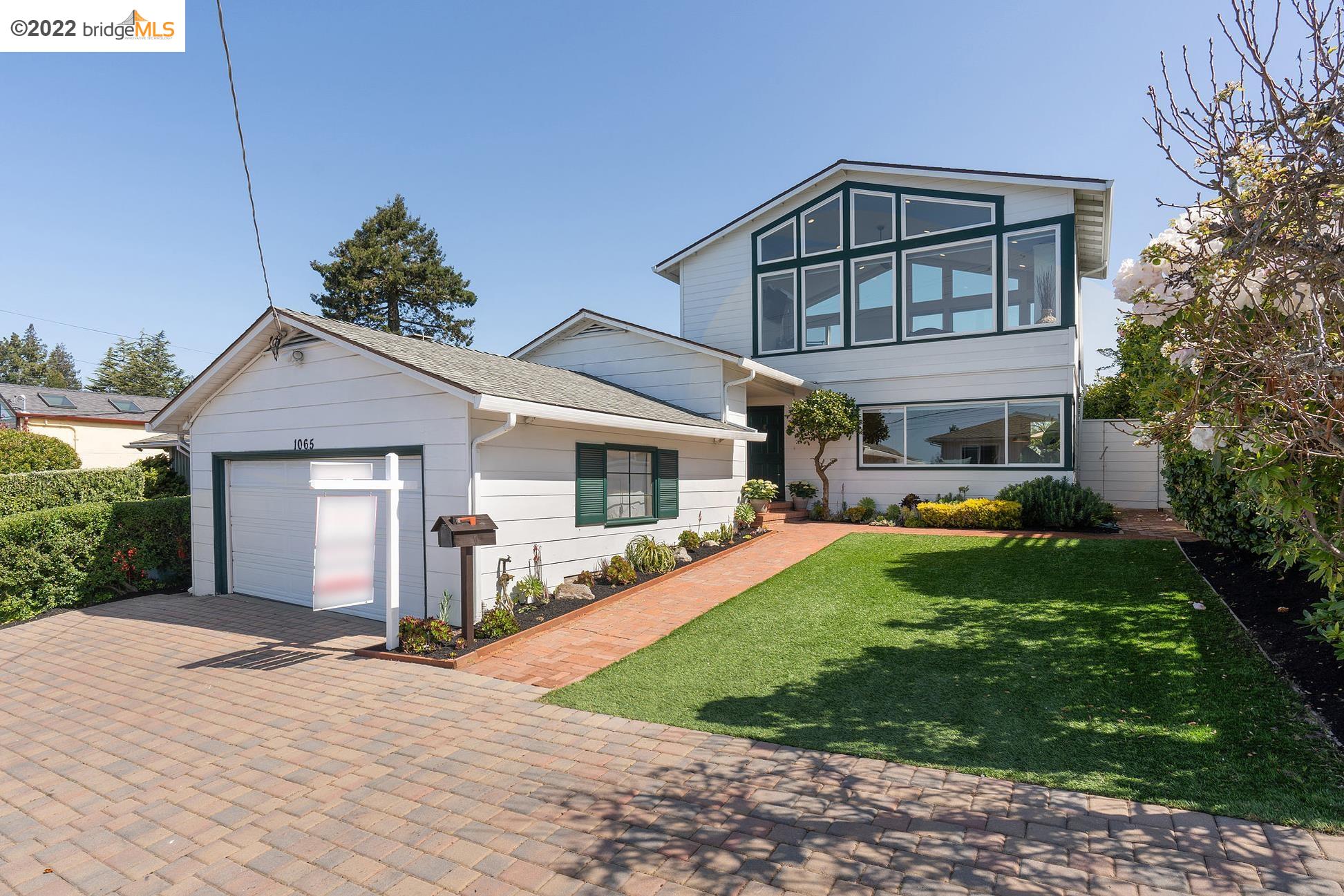 a front view of a house with garden