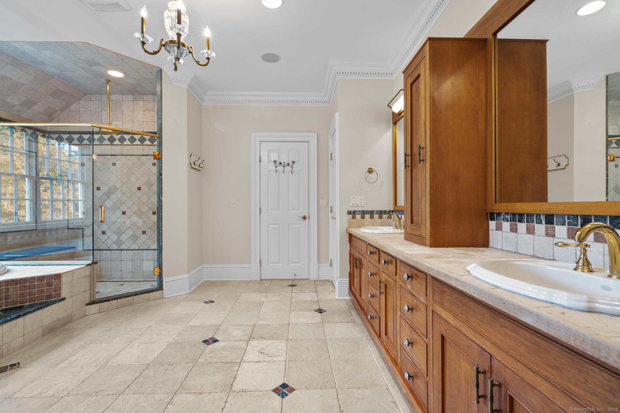 342 Midlock Road Fairfield, CT 06824 - Photo 21 of 40 Primary bath with pool views, jacuzzi tub, walk-in shower, double sink vanity, linen closet.