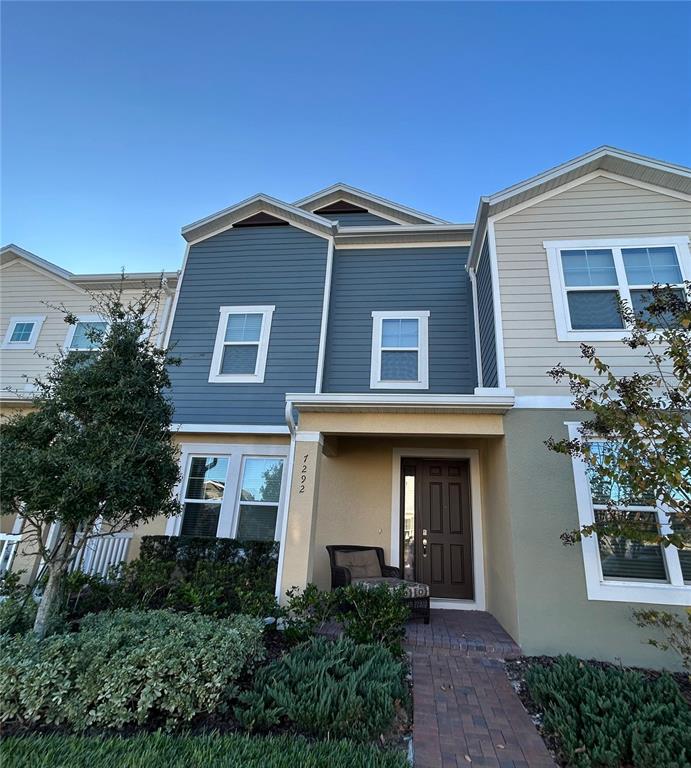 a front view of a house with a yard and trees
