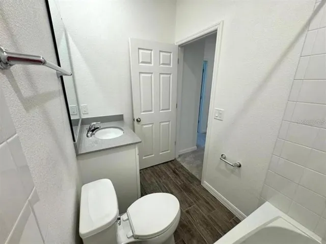 a bathroom with a toilet a sink a shower and mirror