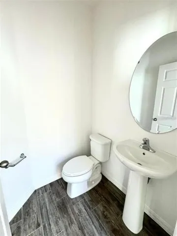 a bathroom with a sink toilet and a mirror