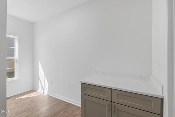 a view of storage and utility room with wooden floor