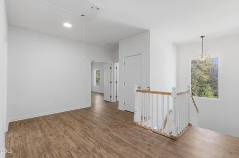 a view of a hallway with wooden floor and entryway