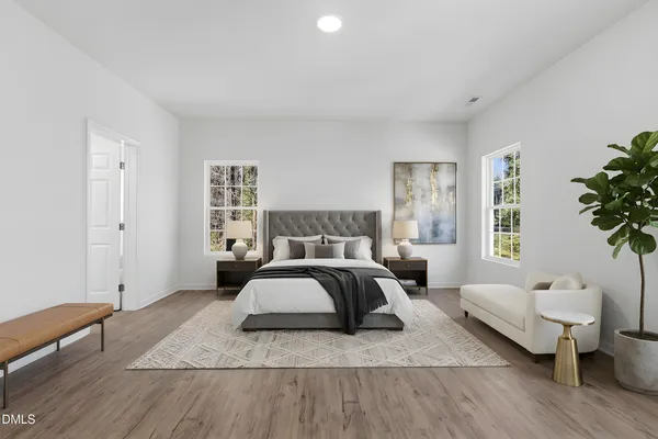 a spacious bedroom with a bed and window