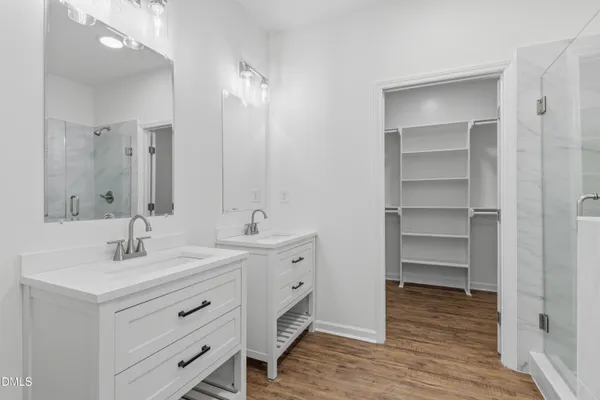 a bathroom with a sink double vanity and a mirror