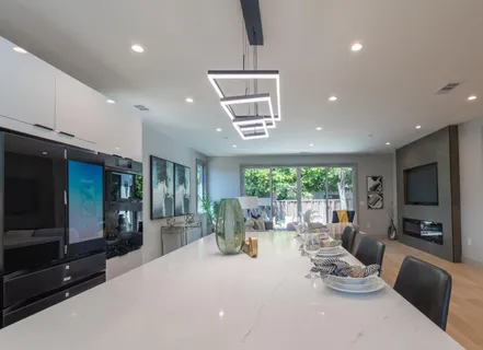 a living room with furniture a large window and flat screen tv