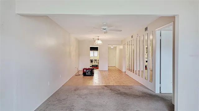 en empty room with a ceiling fan and shower