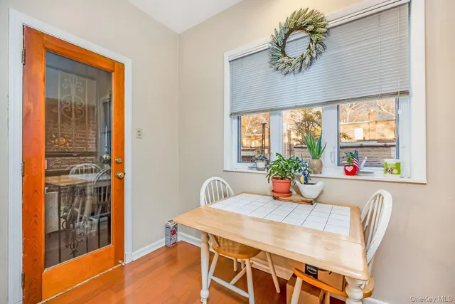a dining room with furniture window and wooden floor