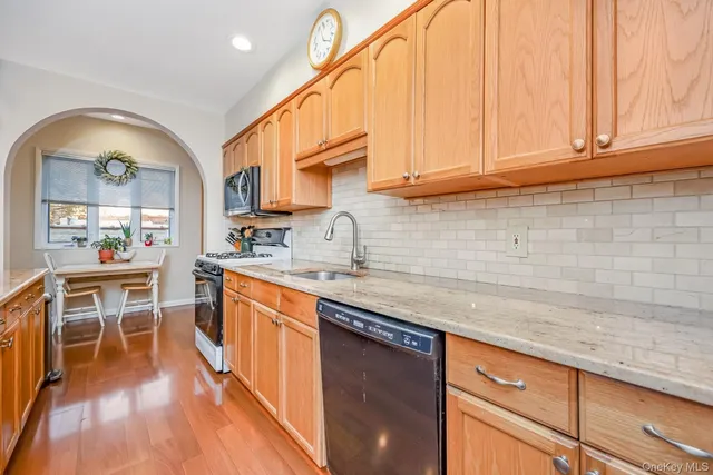 a kitchen with stainless steel appliances granite countertop a sink a stove cabinets counter space and stainless steel appliances