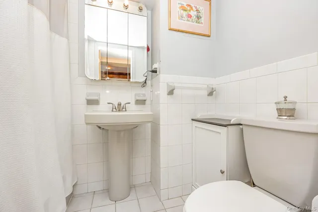 a bathroom with a sink toilet and mirror