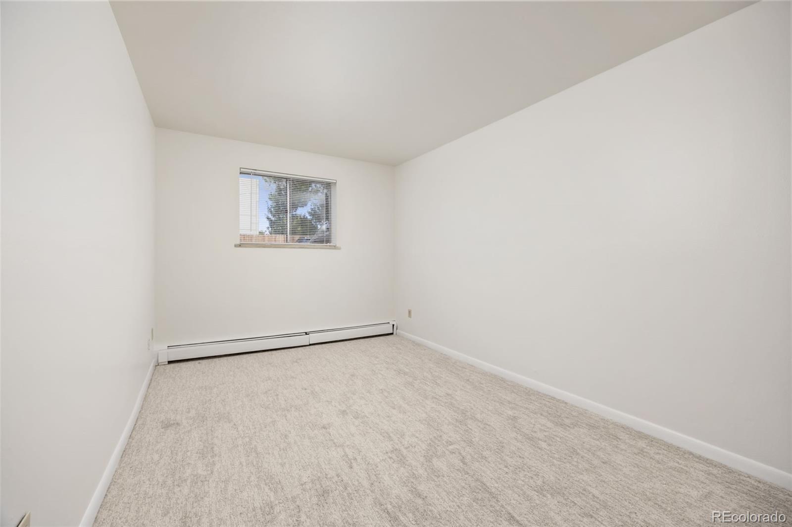 9380 West 49th Avenue, Unit 101 Wheat Ridge, CO 80033 - Photo 9 of 15 an empty room with a workbench