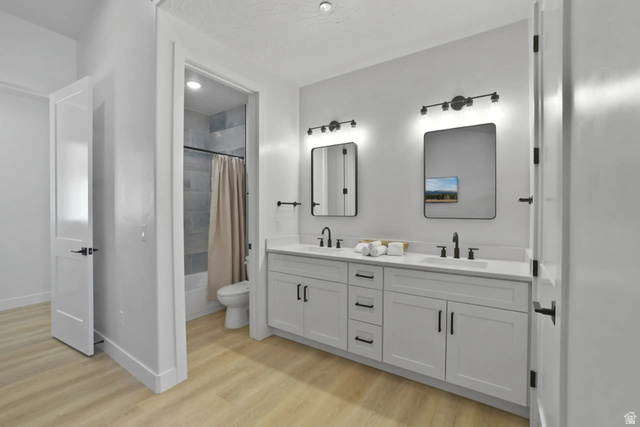 4346 Canterbury Road Hurricane, UT 84737 - Photo 26 of 37 Bathroom with double vanity, light wood-style flooring, and shower / bath combo with shower curtain