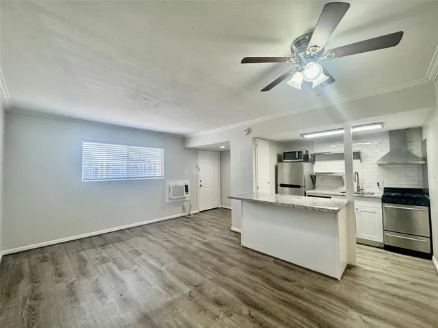 a view of a kitchen with a sink stainless steel appliances and cabinets