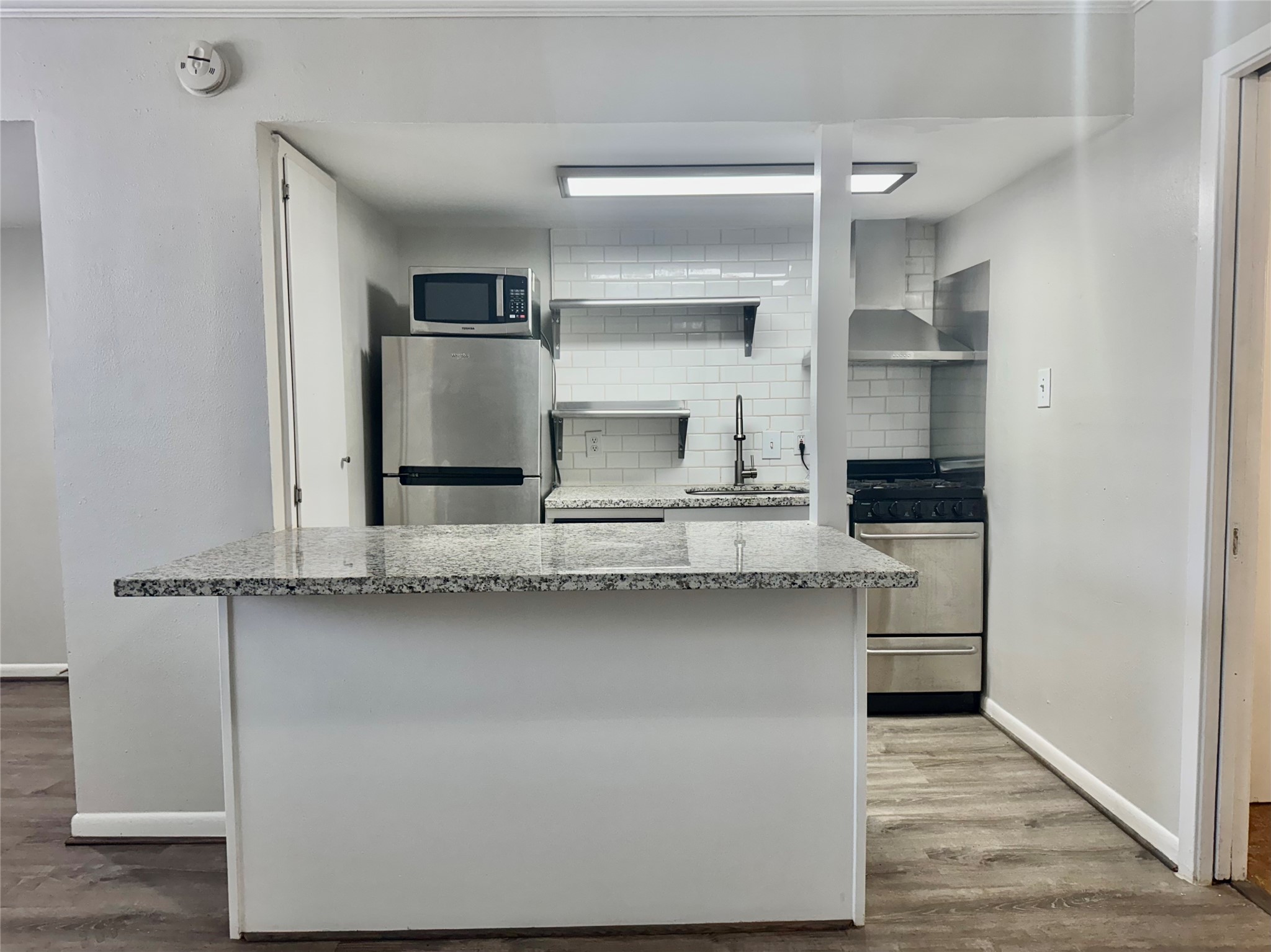 2006 Sul Ross Street, Unit 5 Houston, TX 77098 - Photo 5 of 13 a kitchen with stainless steel appliances a refrigerator and microwave