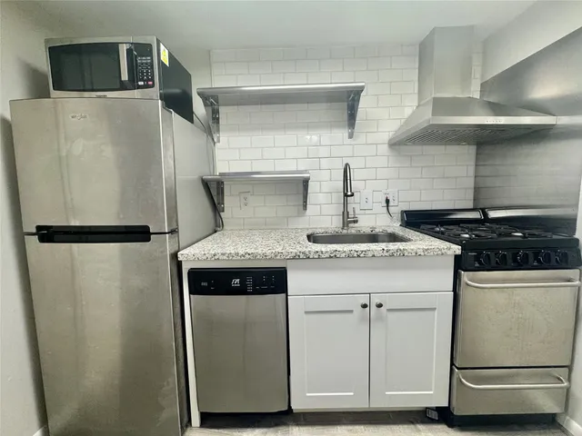 a kitchen with a stove and a refrigerator