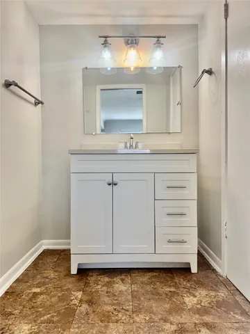 a bathroom with a sink a vanity and a mirror
