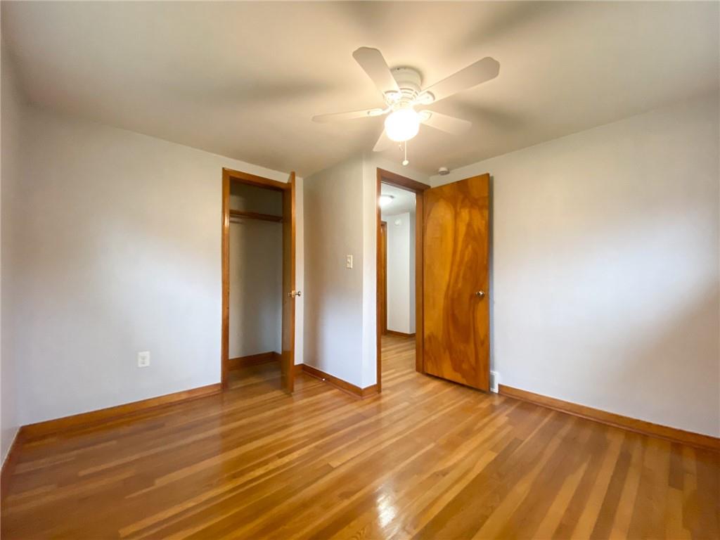 151 Thorne Road Washington, PA 15301 - Photo 14 of 25 an empty room with wooden floor and ceiling fan