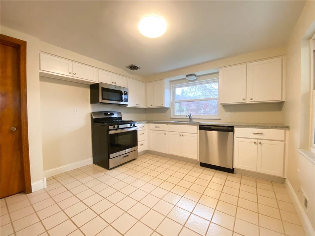 151 Thorne Road Washington, PA 15301 - Photo 7 of 25 a kitchen with a sink a stove top oven and cabinets