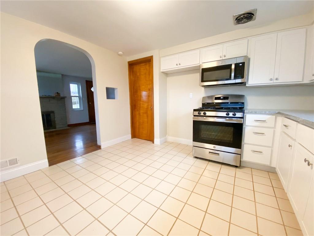151 Thorne Road Washington, PA 15301 - Photo 8 of 25 a kitchen with stainless steel appliances a stove a sink and white cabinets