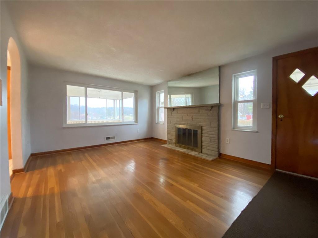 151 Thorne Road Washington, PA 15301 - Photo 9 of 25 an empty room with windows and fireplace