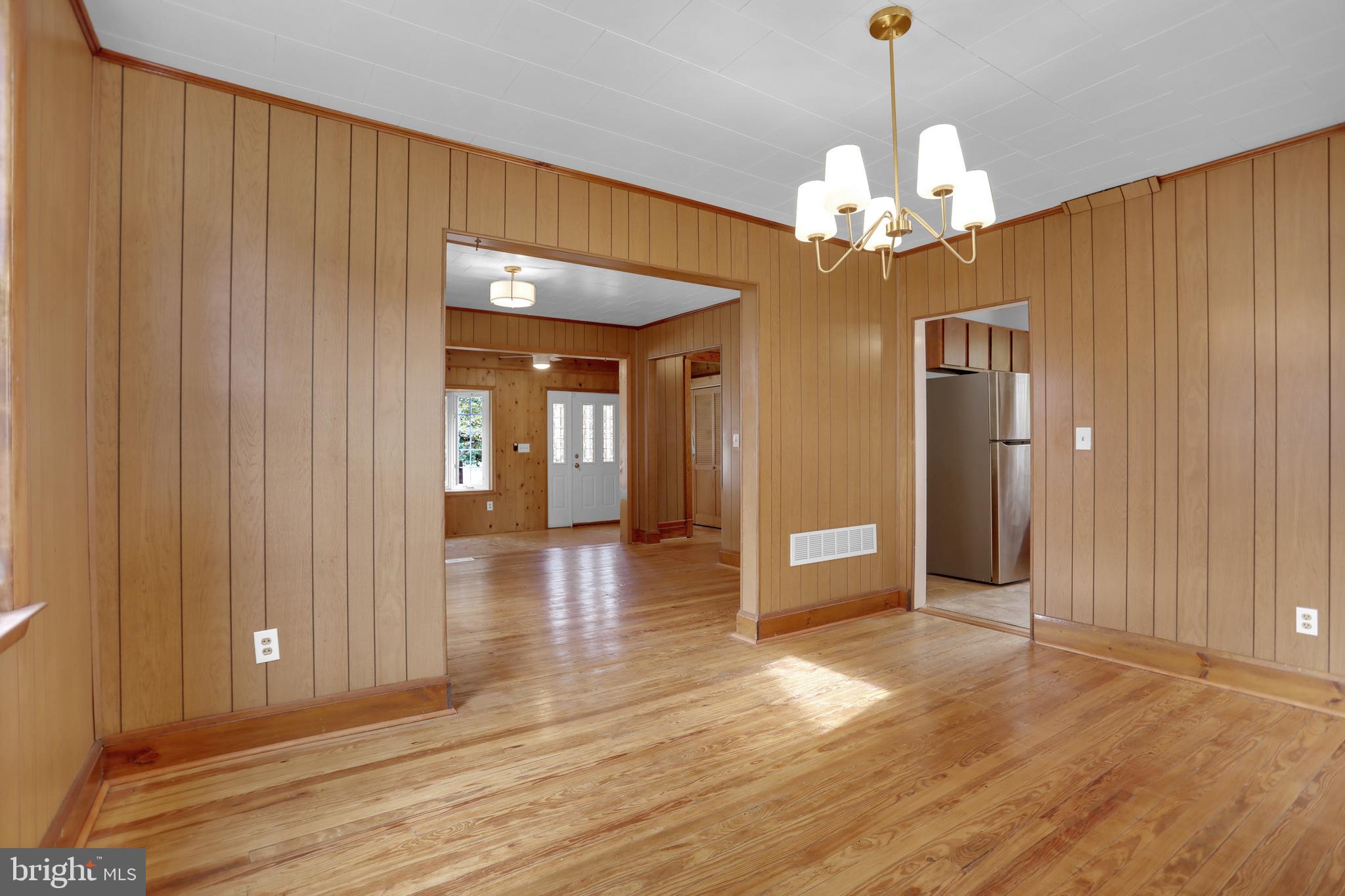 41 Township Road Dundalk, MD 21222 - Photo 11 of 40 a view of a hallway with wooden floor and a chandelier