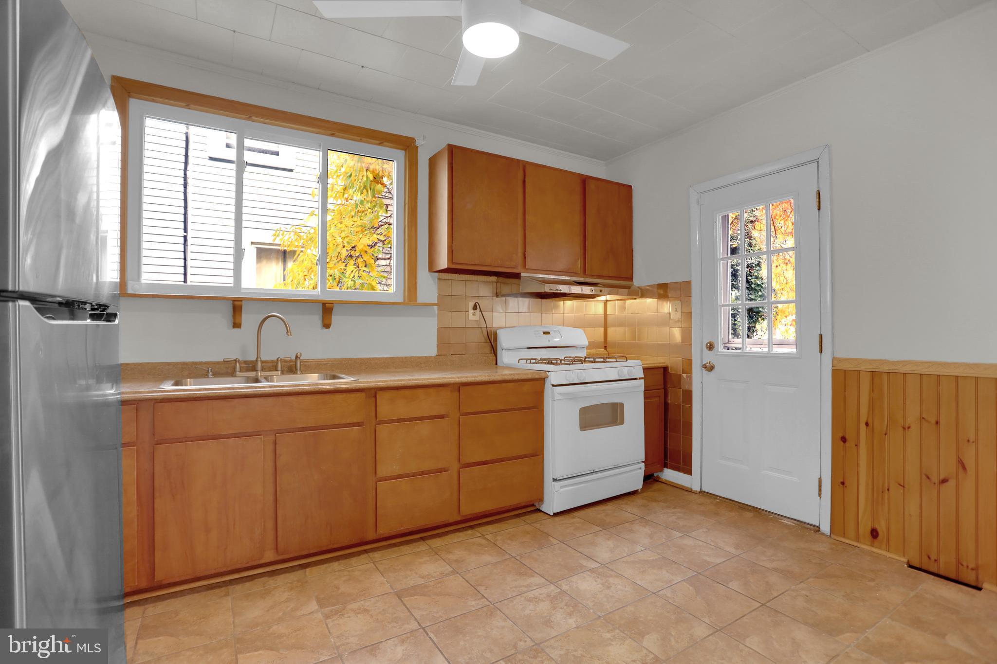 41 Township Road Dundalk, MD 21222 - Photo 14 of 40 a kitchen with sink cabinets and window