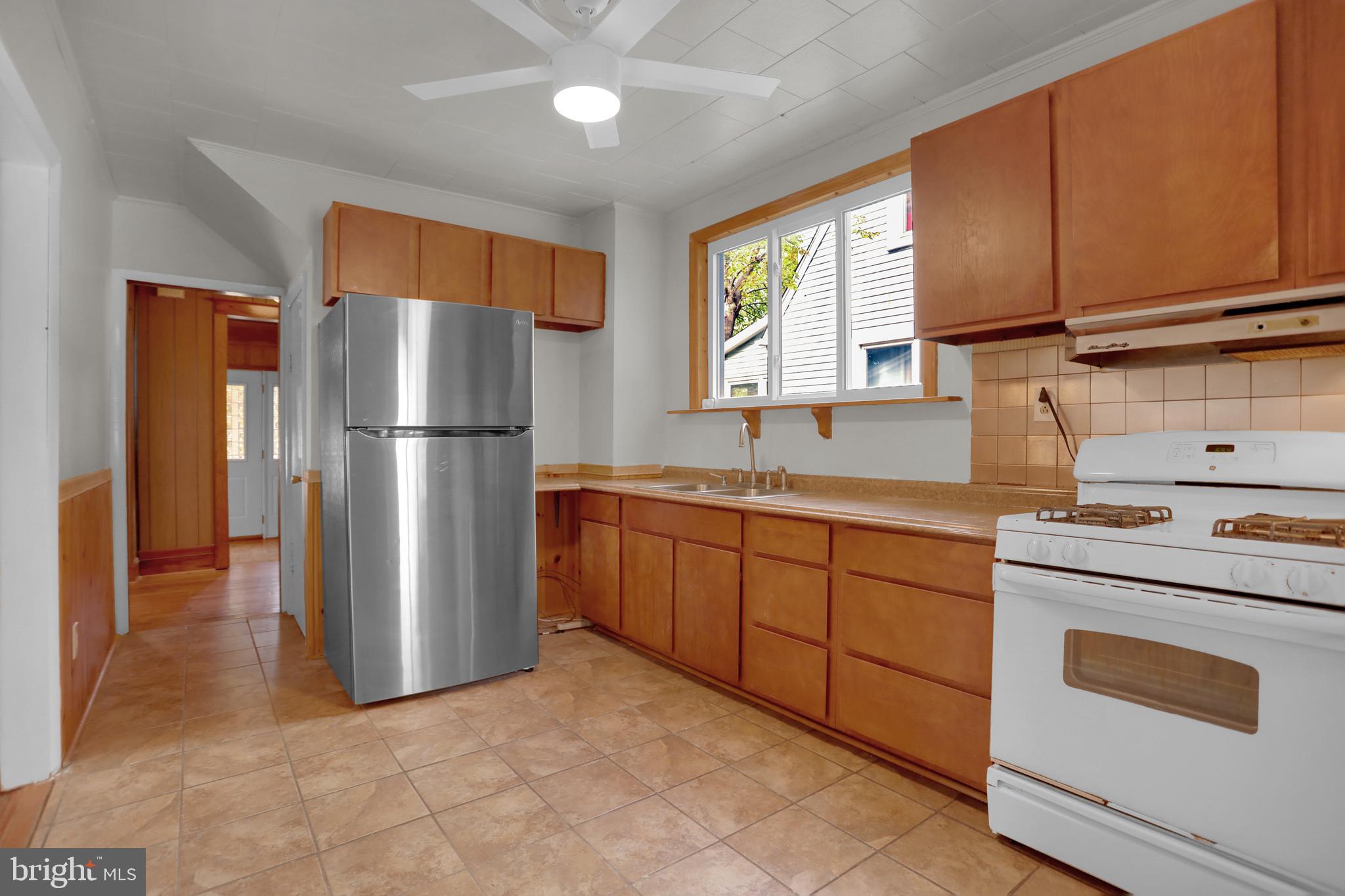41 Township Road Dundalk, MD 21222 - Photo 15 of 40 a kitchen with sink a refrigerator and cabinets