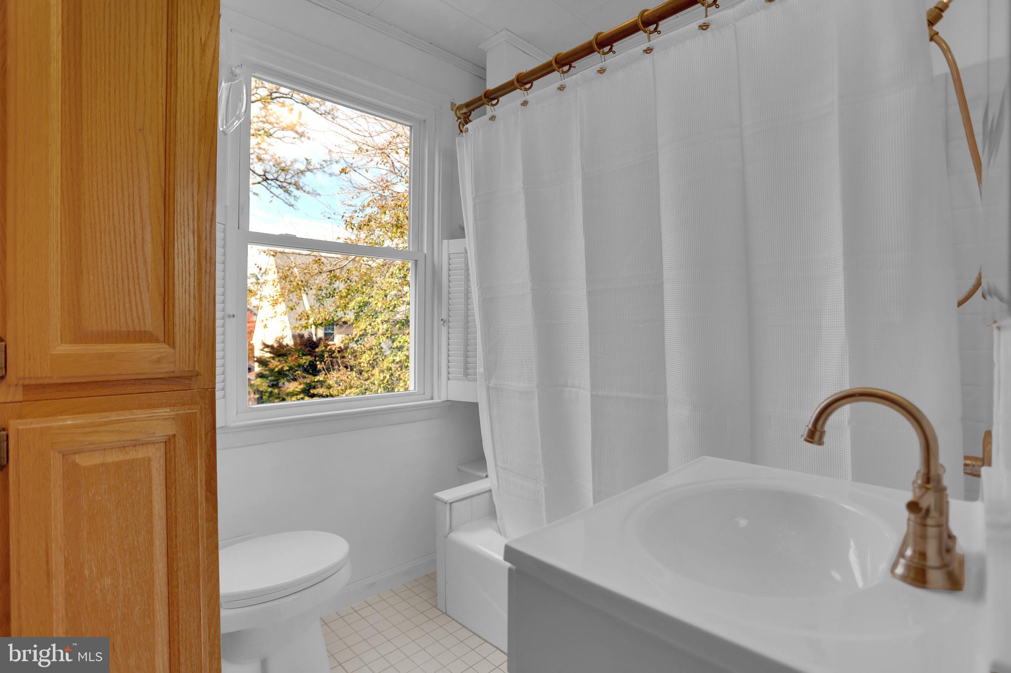 41 Township Road Dundalk, MD 21222 - Photo 24 of 40 a bathroom with a sink a toilet and a window