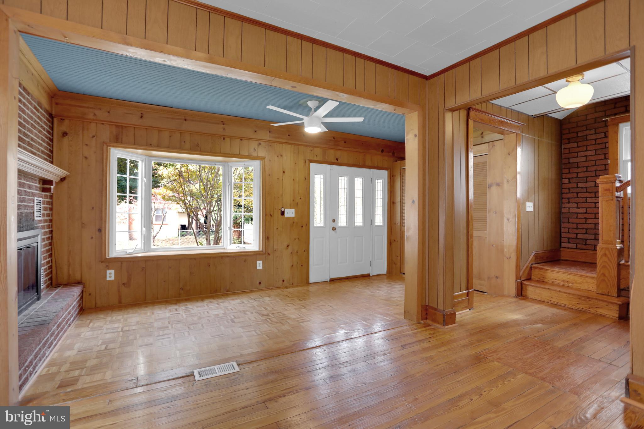 41 Township Road Dundalk, MD 21222 - Photo 8 of 40 an empty room with wooden floor and windows