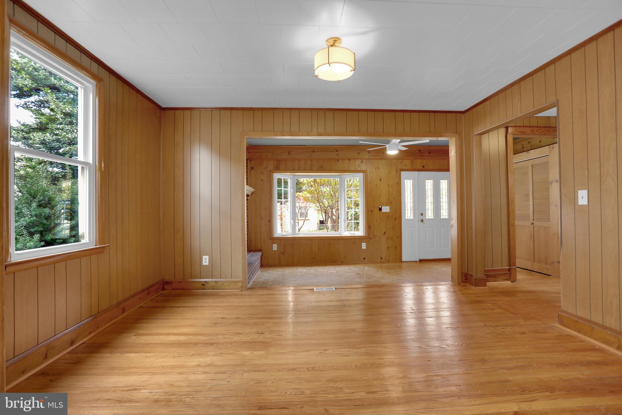 41 Township Road Dundalk, MD 21222 - Photo 9 of 40 an empty room with wooden floor and windows
