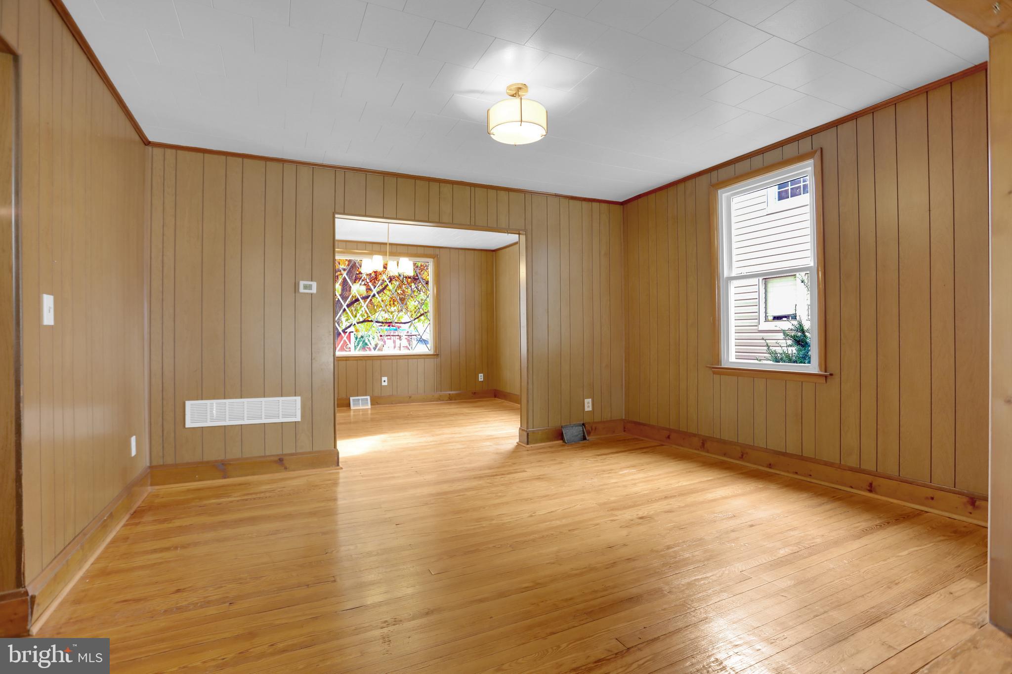 41 Township Road Dundalk, MD 21222 - Photo 10 of 40 a view of an empty room with window and wooden floor