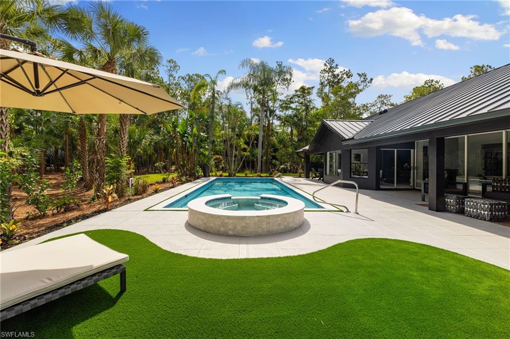 4521 3rd Avenue Northwest Naples, FL 34119 - Photo 27 of 46 a view of a swimming pool with a patio