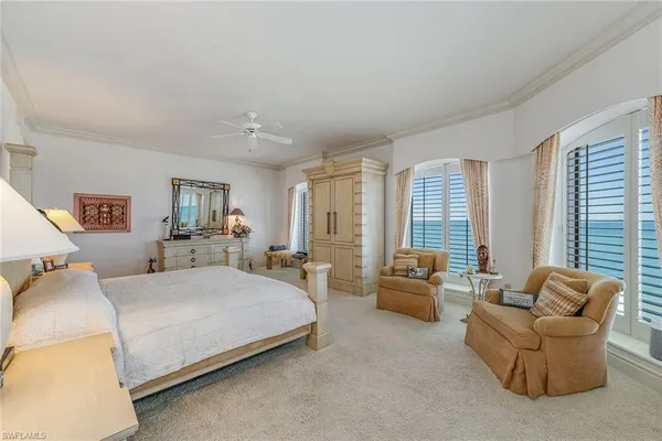 a bedroom with bed couch and window