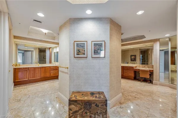 a bathroom with a tub sink and mirror