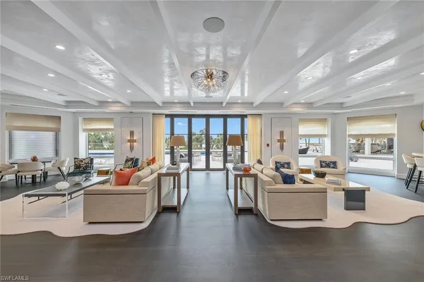 a living room with fireplace furniture and a large window
