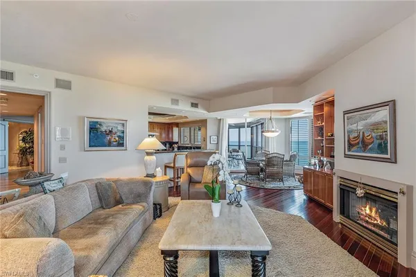 a living room with furniture large window and fireplace