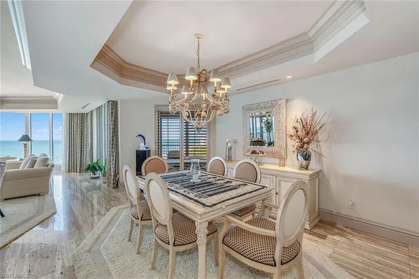 a dining room with furniture and chandelier